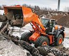 New Hitachi Loader dumping broken rock on pile