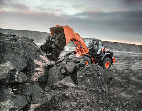 New Hitachi Loader dumping dirt and rock